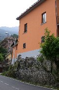 Colorful house built on rocky base in Bellano