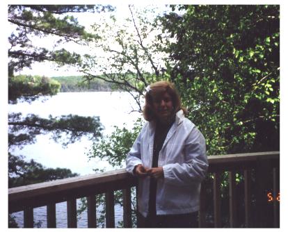 Kitty admires view from cottage balcony