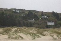 A portion of Harlech Wales seen over the dunes from the beach