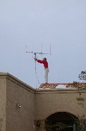 Paul balances on the roof adjusting antenna