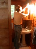 Paul finishes installing mirrored medicine cabinet