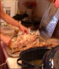 Kitty’s hands are a blur as she cleans off the turkey carcass