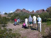 A short hike to a distant ramada near the foot of the rocky hills