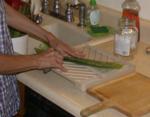 Carefully slitting open the side of well scrubbed leaf