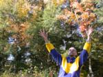 Paul throws milkweed pod contents into the air