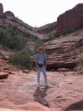 Rains over time smoothed this rock shelf Kitty stands on