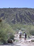 Hill beyond is volcanic rock with patches of desert growth