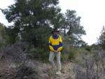 Paul pauses early in the hike amidst several yuccas and a large juniper