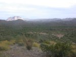 Sunlight bightens a distant mesa in the eastern Superstitions with still early event site in miniature