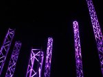 View of light towers from behind camp fire