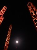 Moon framed in red towers