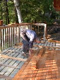 Once trimmed, the log ends will fit into the cap piece on the deck beyond Paul