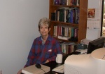 Kitty relaxing with mug of tea at Paul's desk