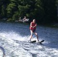 Kids on a north shore dock watch Paul as he skims by before southward turn